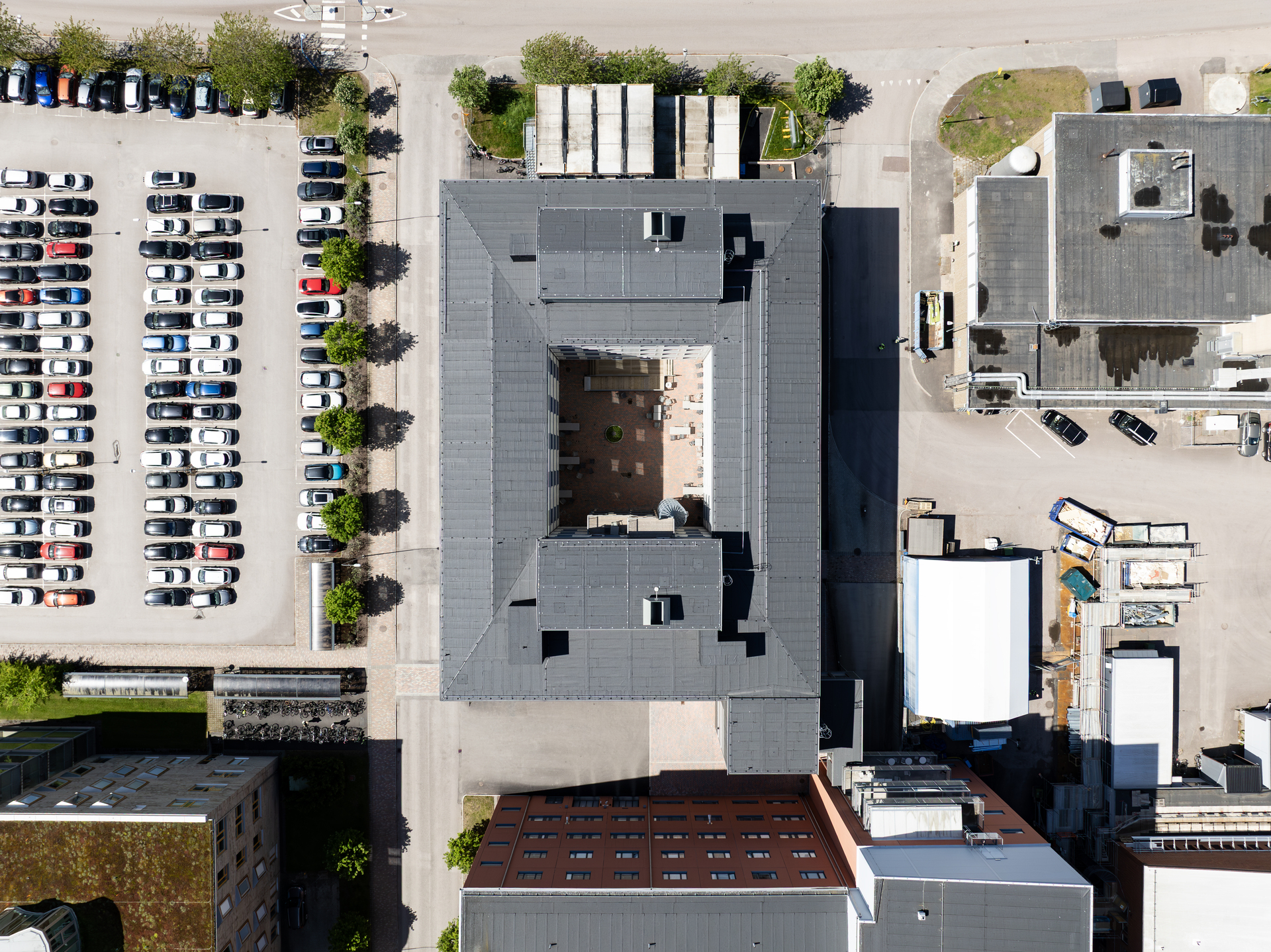 Fugleperspektiv over kontormoduler fra Expandia ved Centralsjukhuset i Karlstad. De modulære kontorbyggene danner en lukket gård i midten og omgis av parkeringsplasser, servicebygg og sykehusets øvrige eiendommer, noe som viser hvordan Expandias fleksible kontormoduler er integrert i sykehusområdet.
